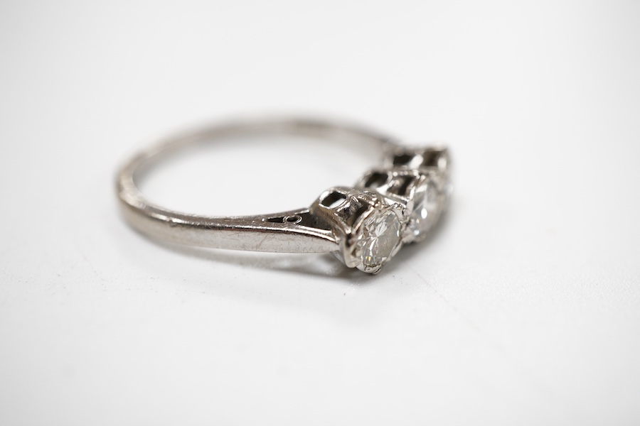 A three-stone diamond ring, set with three brilliant-cut diamonds totalling approximately 0.50 carats, mounted in platinum, size R1/2, British hallmarks, gross weight approximately 4 grams